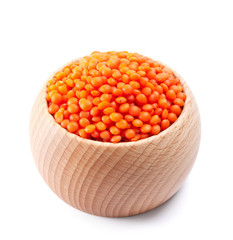 wooden bowl full of red lentils isolated on white
