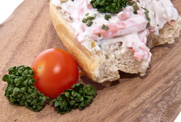 Rolls with meat salad on a cutting board