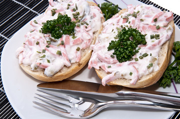 Rolls with meat salad on a plate