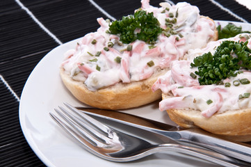 Rolls with meat salad on a plate