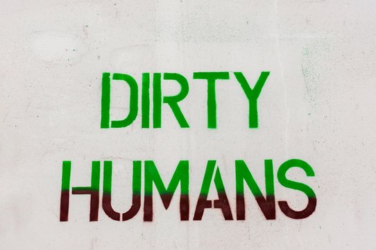Dirty humans written on white wall