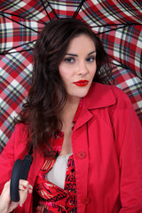 Woman in red with a tartan umbrella