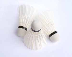 Fototapeta na wymiar Three white feather badminton shuttlecocks closeup