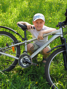 smiling boy on bicycle