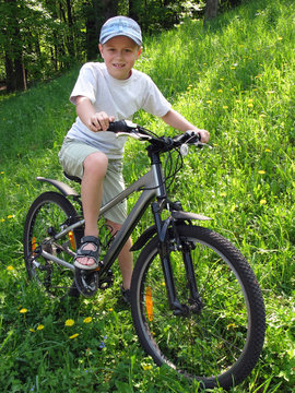 smiling boy on bicycle