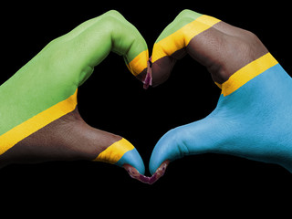 Heart and love gesture by hands colored in tanzania flag for tou