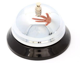 Hotel bell with hand reflection