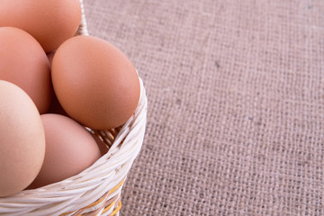 Eggs in basket on a sacking background