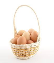 Eggs in basket isolated on white background