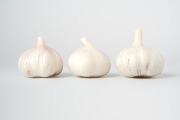 Fresh three garlics on grey background