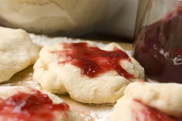 Dough with marmelade on wooden board