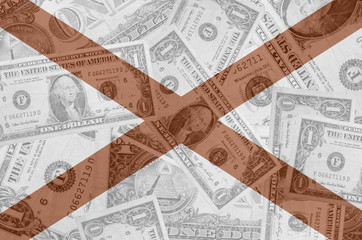 US state of alabama flag with transparent dollar banknotes in ba