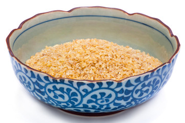 bulgur in blue plate close up isolated