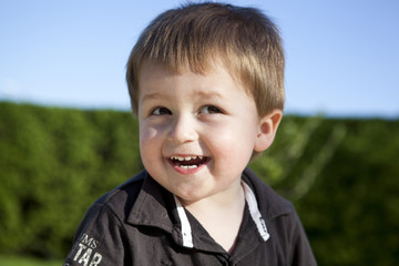 dziecko - szczęśliwy chłopiec - przedszkolak w ogrodzie - lato - zieleń