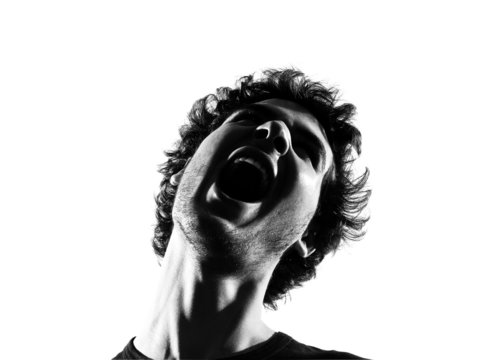 young man silhouette screaming angry portrait