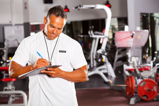 gym supervisor writing report in gym