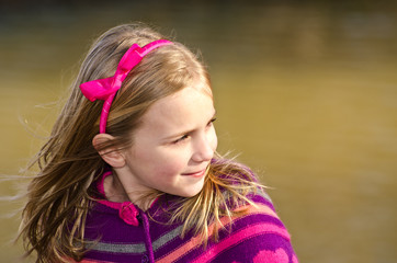 Winter portrait of pretty young girl child wearing knit poncho