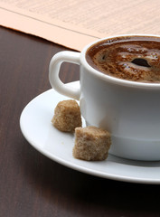 Cup of coffee and newspaper