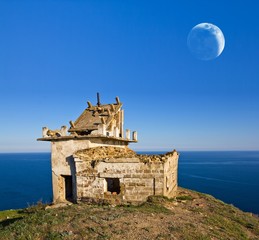 old broken lighthouse on a sea cape © Yuriy Kulik