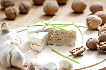 cheese brie filled with cheese mixture of chopped walnuts and ga