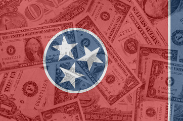 Fototapeta na wymiar US state of tennessee flag with transparent dollar banknotes in