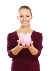 Young beautiful woman with piggy bank