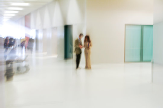 two people standing indoor, blur photo