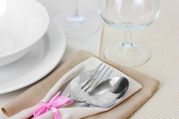 Table setting with fork, knife, plates, and napkin