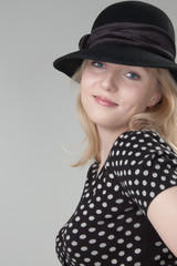 Young beautiful sexy smiling blonde woman in a black hat close-u