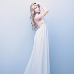 portrait of beautiful elegant blond woman in white dress