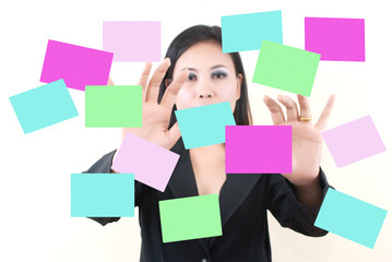 Business lady pushing note paper on the whiteboard.