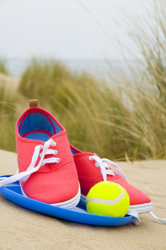 shoes, ball and frisbee on beach © djtaylor