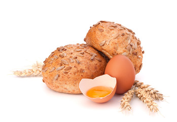 Bun with seeds and broken egg