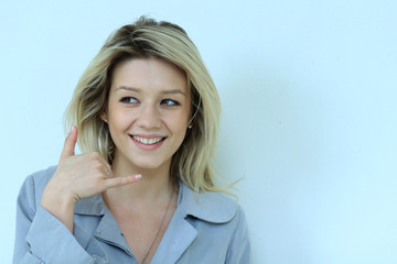 Beautiful woman making a call me gesture