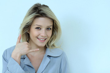 Beautiful woman making a call me gesture