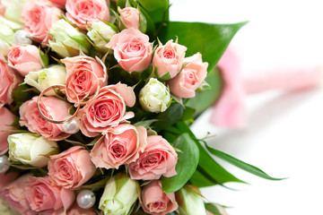 wedding rings of the groom and the bride on a bunch of flowers.