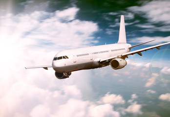 Big jet plane flying above clouds