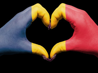 Heart and love gesture by hands colored in chad flag  for touris
