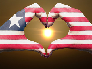 Heart and love gesture by hands colored in liberia flag during b