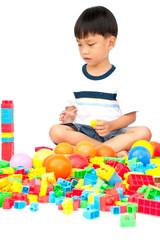 Little boy playing with toy on white background