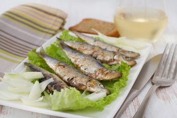 fried sardines on lettuce