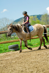 Horse riding - lovely girl is riding a horse