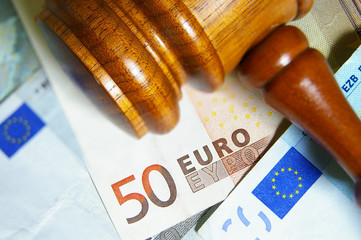 Closeup of a gavel and Euro notes