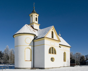 Fototapeta na wymiar small church or chapel at wonderful winter day with blue sky