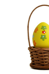 Yellow Easter egg into a basket