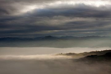 Wind Valley in Romagna (Italy) under the clouds, foggy with a sunshine