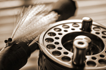 Fly fishing reel and lure on dock