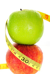 Apple with measuring tape isolated in white