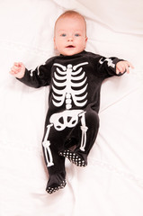 Cute baby portrait in funny skeleton suit isolated on white back