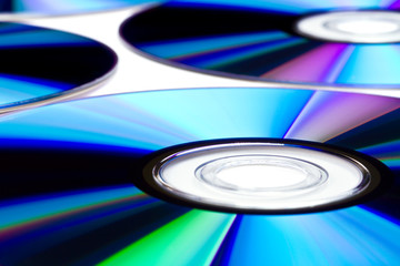 Pattern of cd/dvd disks over white